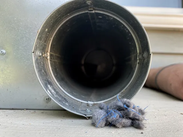Plainville Dryer Vent Cleaning technician using specialized equipment to clear severe dryer vent blockage in Plainville